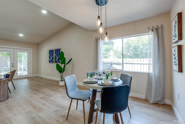 dining room with french doors, light hardwood / wood-style floors, and a healthy amount of sunlight