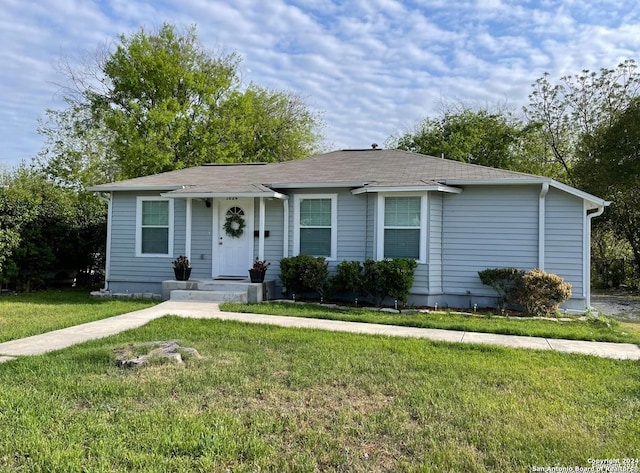 ranch-style home with a front lawn