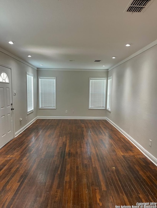 foyer entrance featuring dark hardwood / wood-style flooring and ornamental molding