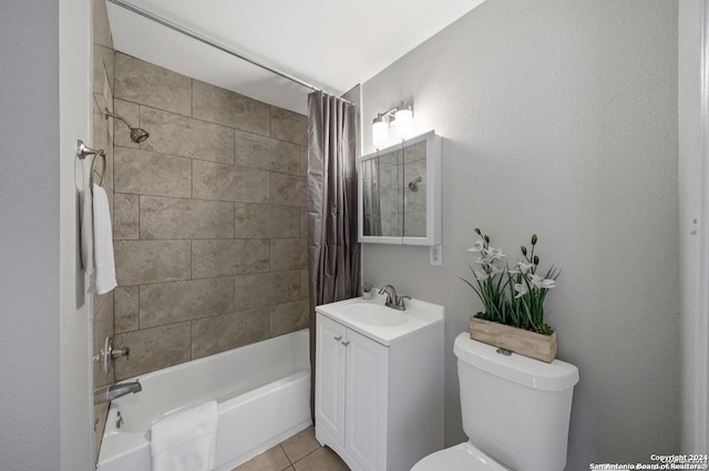 full bathroom featuring tile patterned flooring, shower / bath combo with shower curtain, vanity, and toilet