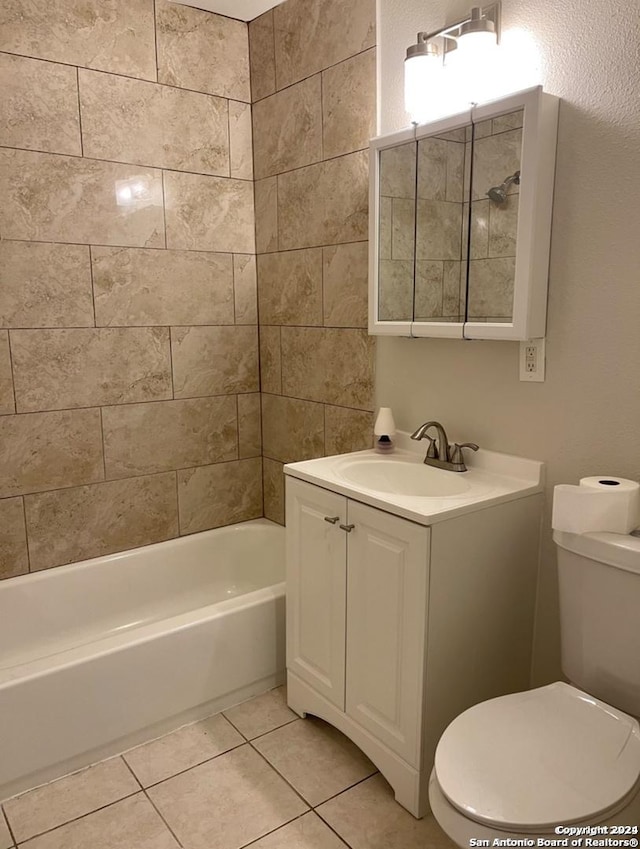 full bathroom featuring toilet, vanity, tile patterned floors, and tiled shower / bath combo