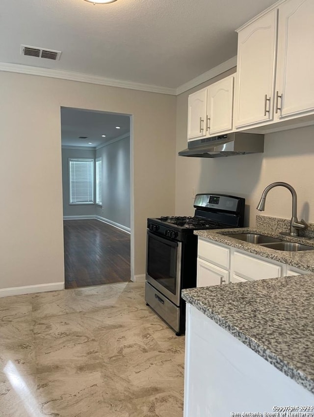 kitchen featuring sink, stone countertops, stainless steel range with gas stovetop, white cabinets, and light wood-type flooring