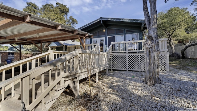 wooden deck with a sunroom