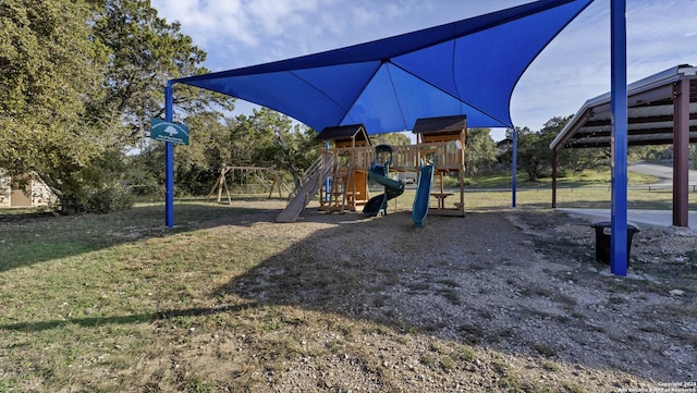 view of jungle gym featuring a lawn