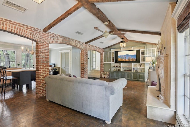 living room with vaulted ceiling with beams, dark parquet flooring, and ceiling fan with notable chandelier