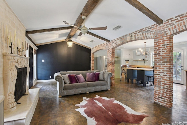 living room featuring dark parquet floors, ceiling fan with notable chandelier, lofted ceiling with beams, and brick wall