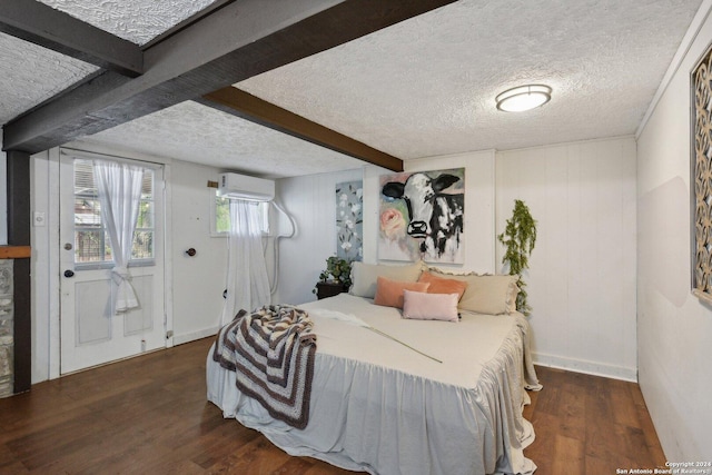 bedroom with beamed ceiling, a textured ceiling, dark hardwood / wood-style floors, and an AC wall unit