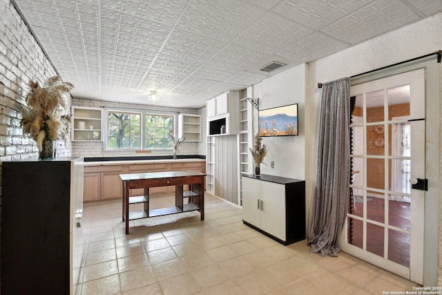 kitchen featuring light brown cabinets and tasteful backsplash