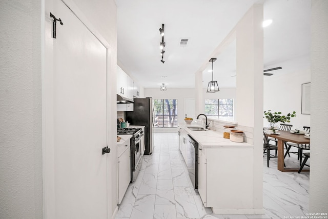 kitchen featuring ceiling fan, sink, stainless steel appliances, pendant lighting, and white cabinets