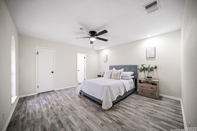 bedroom with ceiling fan and wood-type flooring