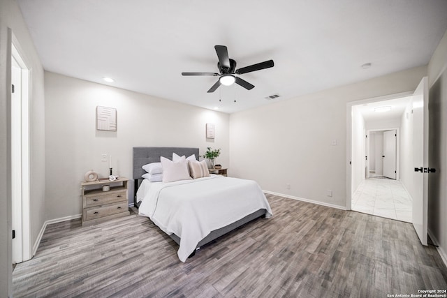 bedroom with hardwood / wood-style floors and ceiling fan