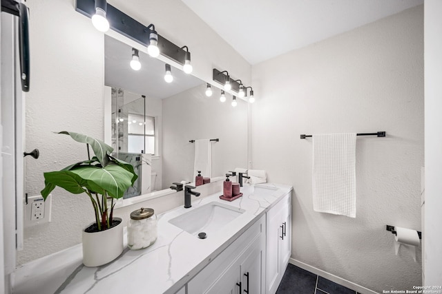 bathroom featuring tile patterned flooring, vanity, and an enclosed shower