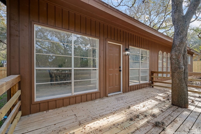 view of exterior entry featuring a wooden deck