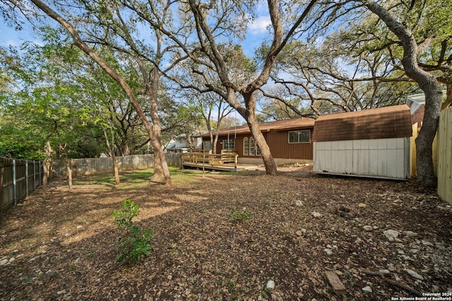 view of yard with a shed and a deck