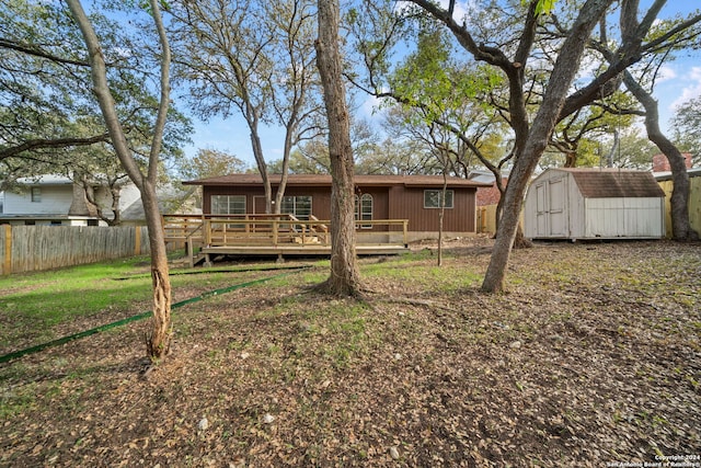 back of property with a storage unit and a wooden deck