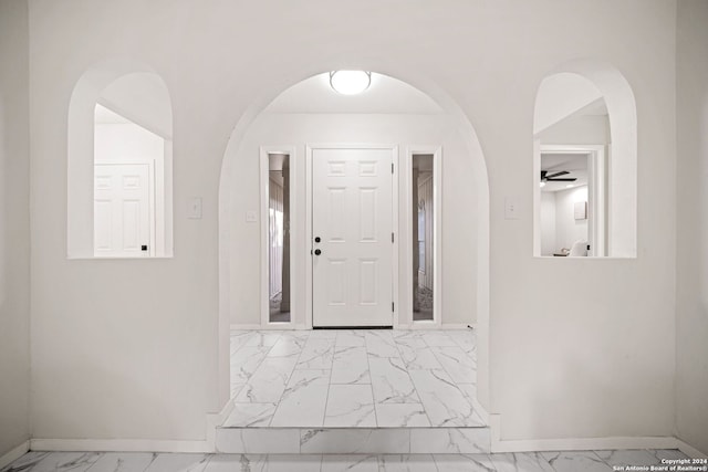 entrance foyer with ceiling fan