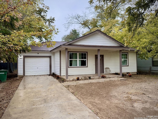 view of front of property with covered porch and a garage