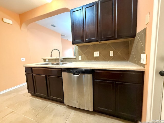 kitchen featuring dishwasher, sink, backsplash, dark brown cabinets, and light tile patterned flooring