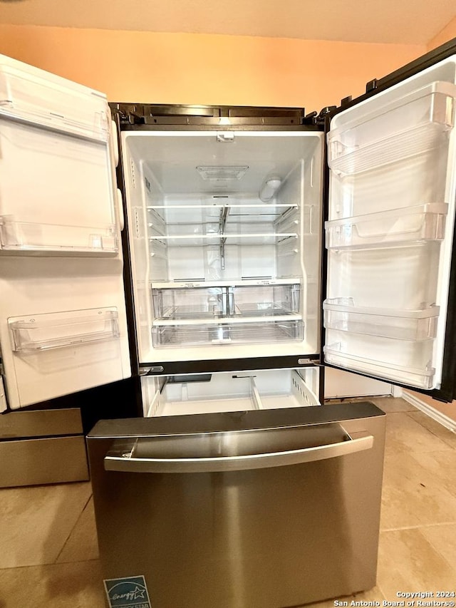 interior details featuring stainless steel fridge