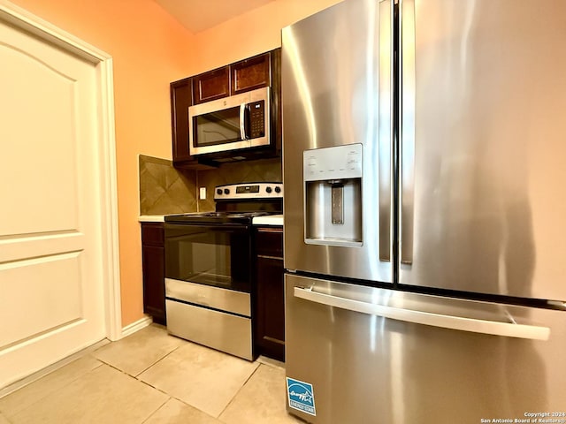 kitchen with decorative backsplash, appliances with stainless steel finishes, dark brown cabinetry, and light tile patterned floors