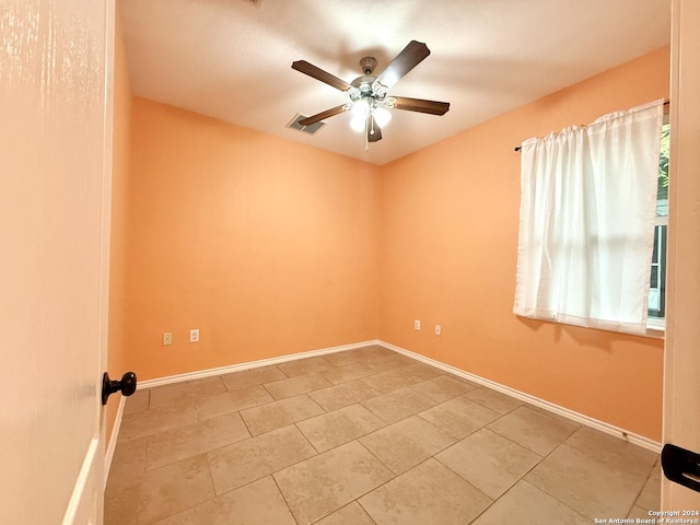 unfurnished room featuring tile patterned floors and ceiling fan