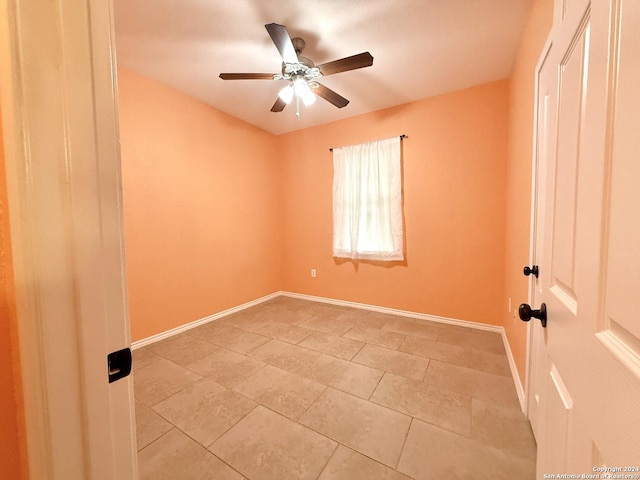 empty room featuring ceiling fan and light tile patterned flooring