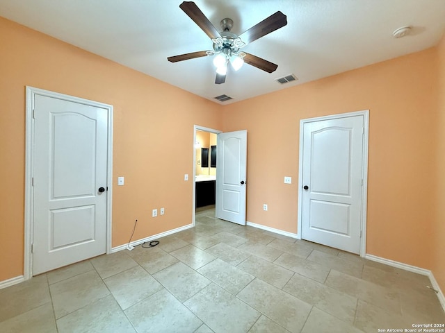 unfurnished bedroom featuring light tile patterned floors and ceiling fan