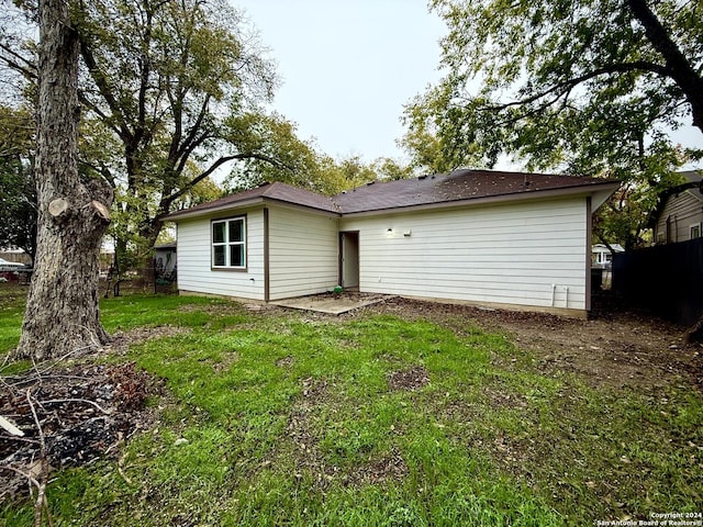 back of house with a lawn