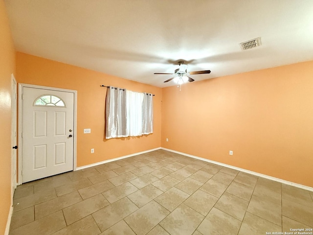 tiled entryway with ceiling fan