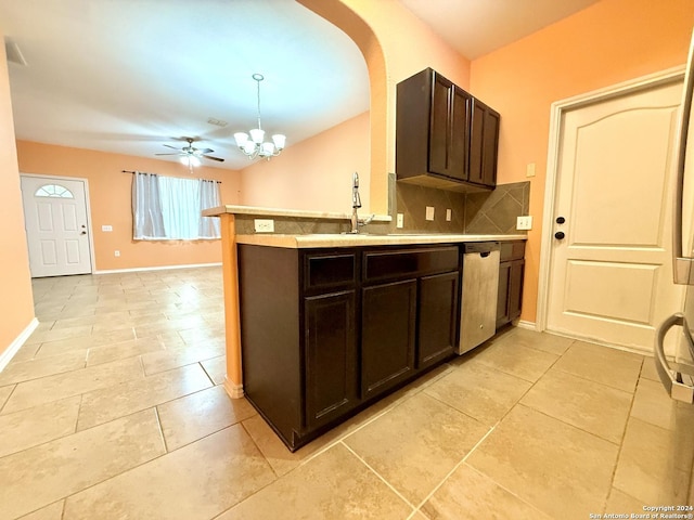 kitchen featuring pendant lighting, backsplash, ceiling fan with notable chandelier, stainless steel dishwasher, and dark brown cabinetry