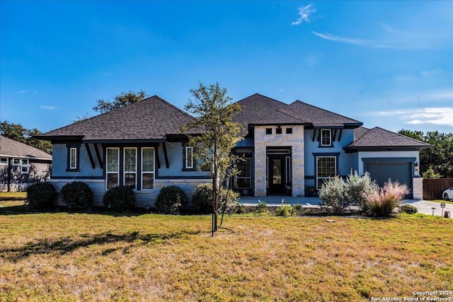 view of front of property featuring a garage and a front yard