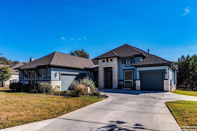 view of front of property with a front yard and a garage