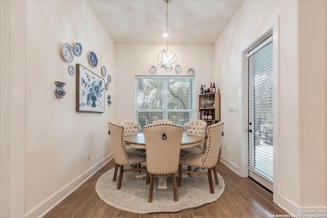 dining room featuring a notable chandelier and dark hardwood / wood-style floors