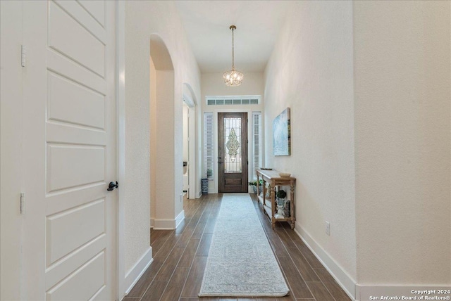 foyer featuring dark hardwood / wood-style floors and a notable chandelier