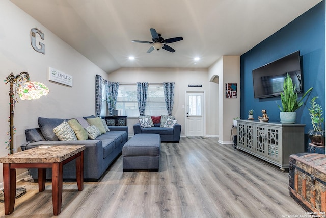 living room featuring ceiling fan, light hardwood / wood-style floors, and lofted ceiling