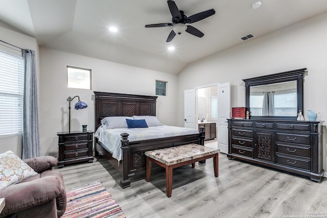 bedroom featuring connected bathroom, ceiling fan, vaulted ceiling, and light wood-type flooring