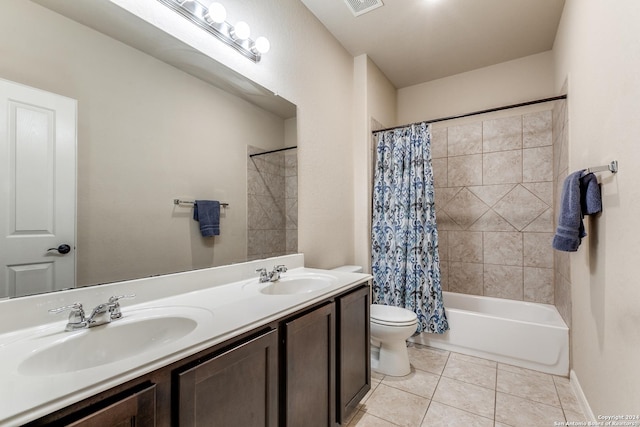 full bathroom featuring tile patterned flooring, shower / tub combo, vanity, and toilet