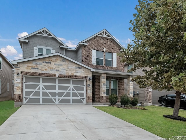 craftsman house with a garage and a front yard