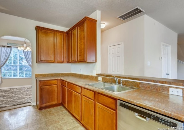 kitchen with sink, stainless steel dishwasher, and a textured ceiling