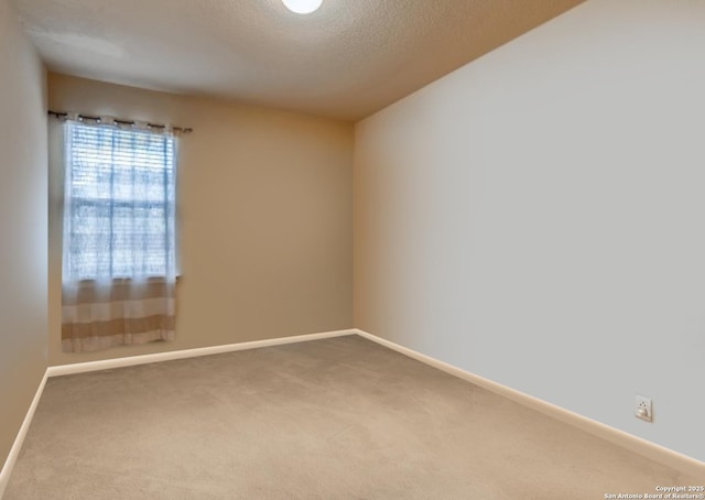 spare room featuring a textured ceiling and carpet flooring