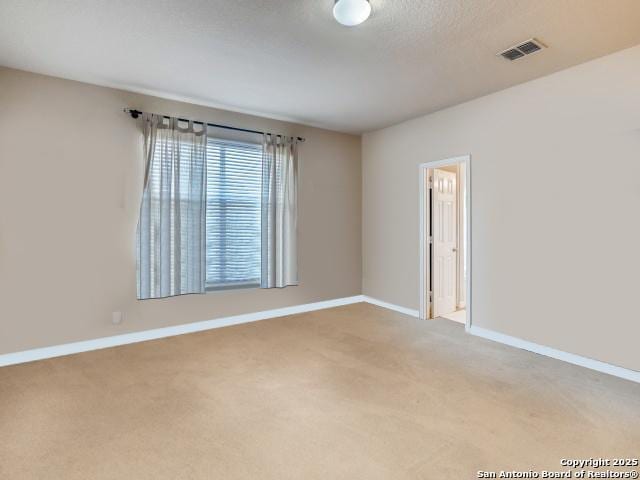 unfurnished room with light carpet