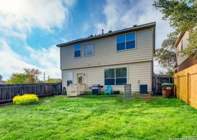 back of property featuring central AC and a lawn