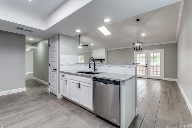 kitchen featuring dishwasher, french doors, sink, white cabinetry, and kitchen peninsula