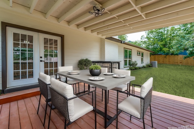 wooden deck with a lawn and central AC