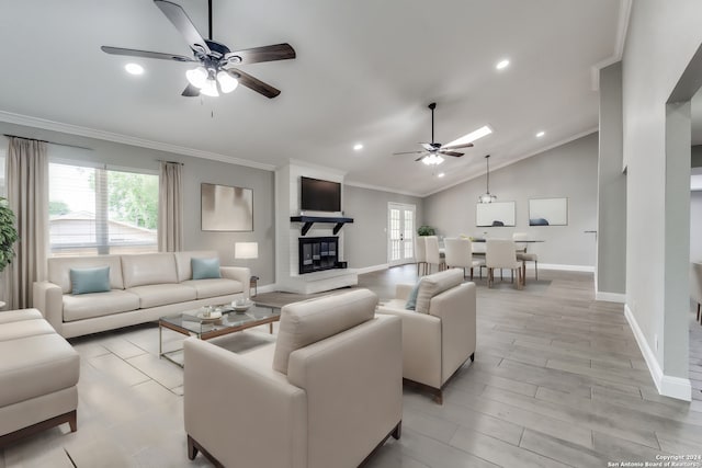 living room featuring plenty of natural light, lofted ceiling, and crown molding