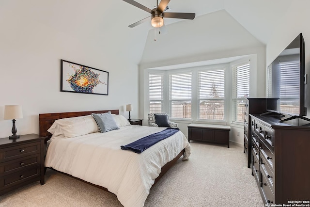 bedroom with light colored carpet, high vaulted ceiling, and ceiling fan