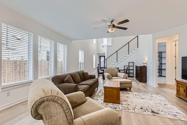 living room featuring ceiling fan and light hardwood / wood-style flooring