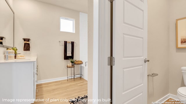 bathroom with vanity, wood-type flooring, and toilet