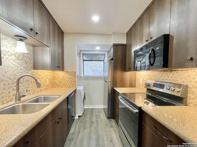 kitchen featuring backsplash, light hardwood / wood-style floors, sink, and appliances with stainless steel finishes