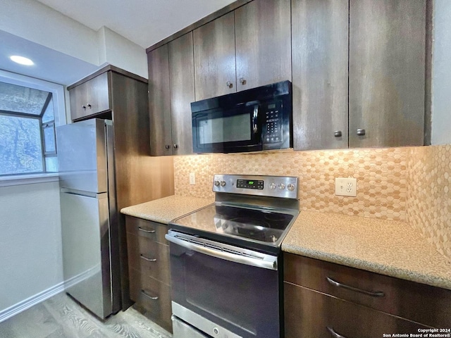 kitchen with dark brown cabinetry, decorative backsplash, light hardwood / wood-style flooring, and stainless steel appliances